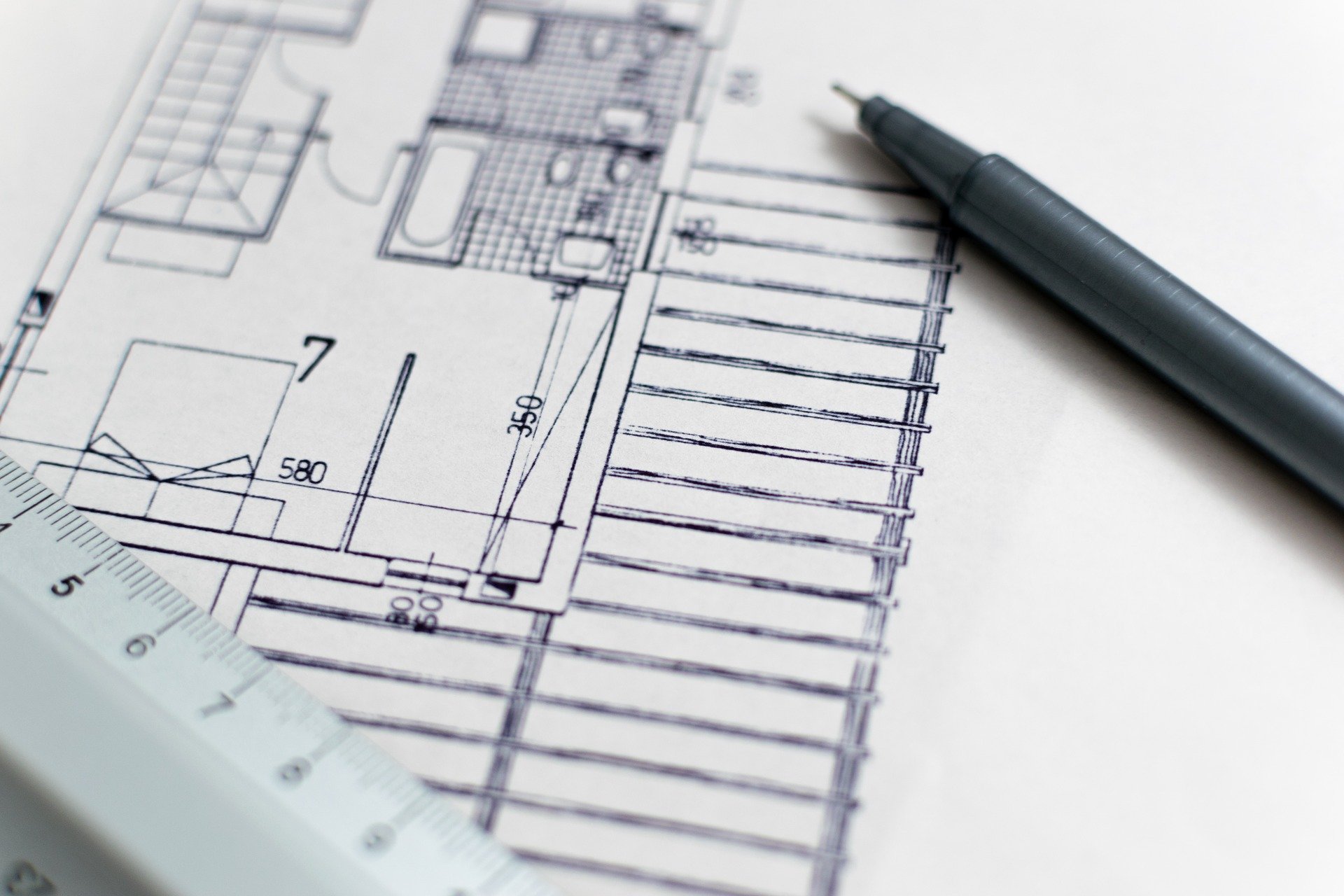 Floor plan with a ruler and pen on it.