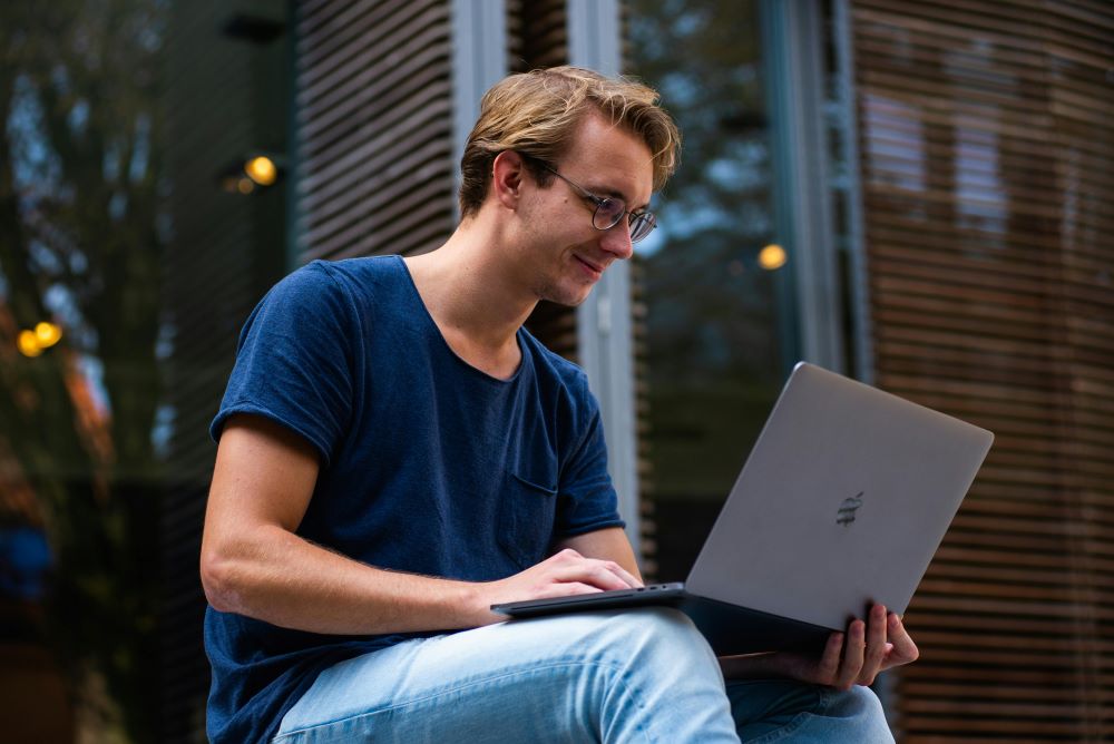 A student looking at a laptop