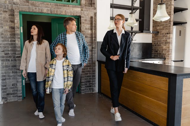 Real estate agent showing a property to a family and explaining how to find your dream home