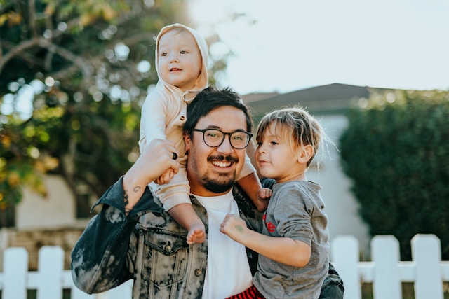 A father with two kids smiling