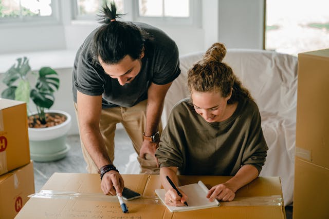 Couple writing a checklist surrounded by boxes