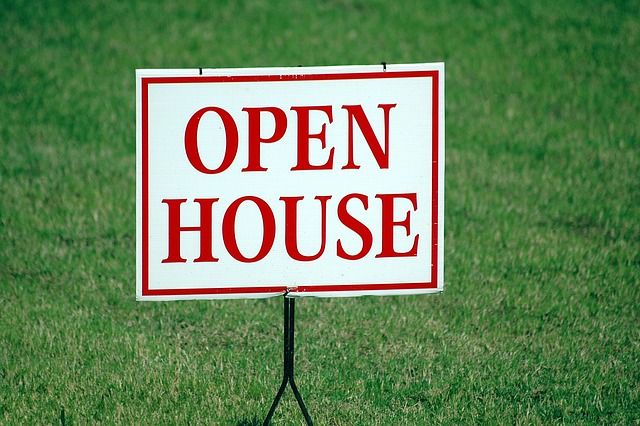 Open house sign on the green lawn