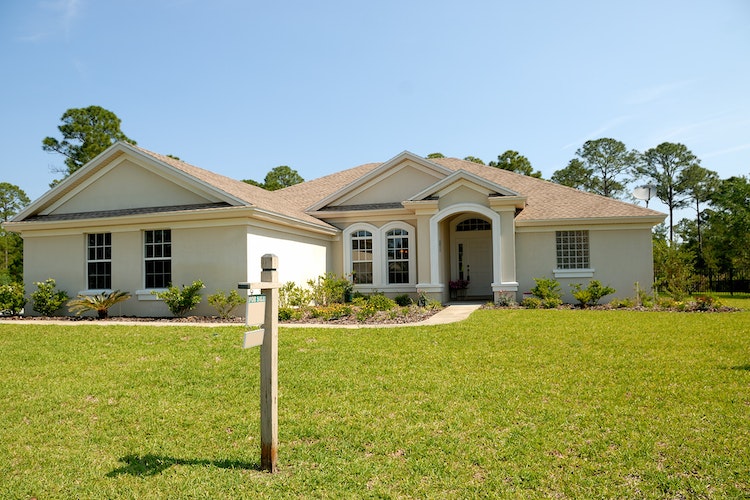 Home with a FOR SALE sign