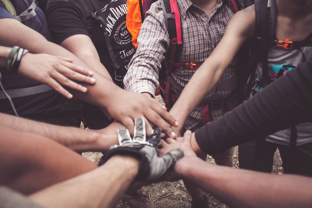 People doing group hand cheer together