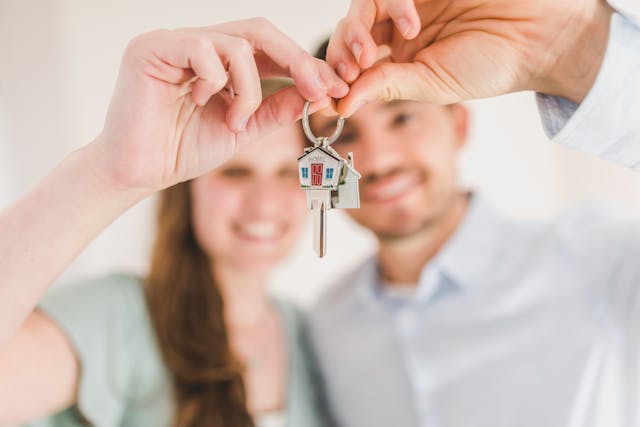 Happy couple holding keys to their new home