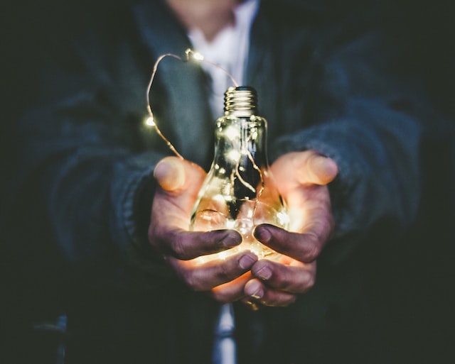 a person holding a light bulb