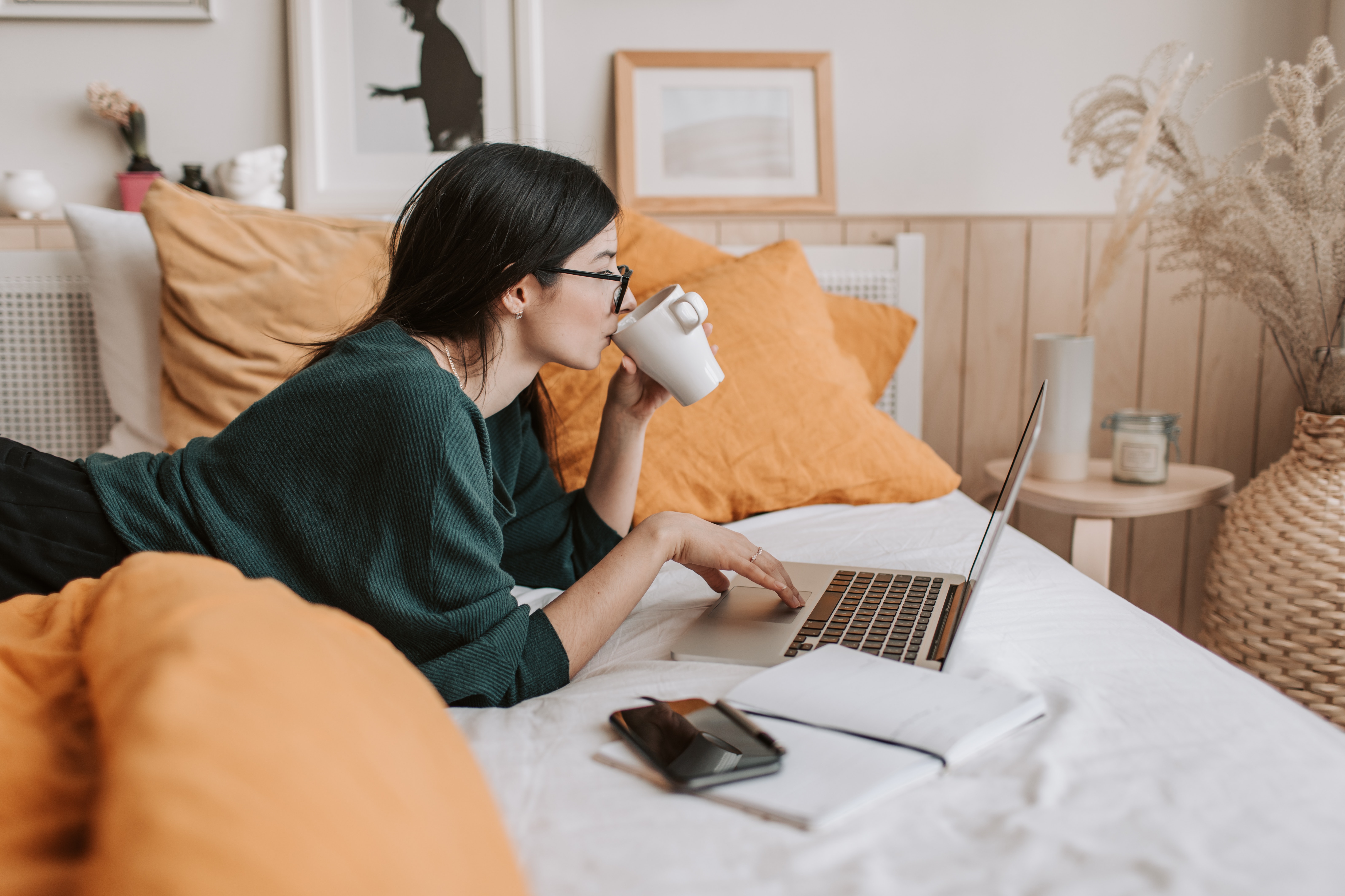 A woman looking at her laptop.