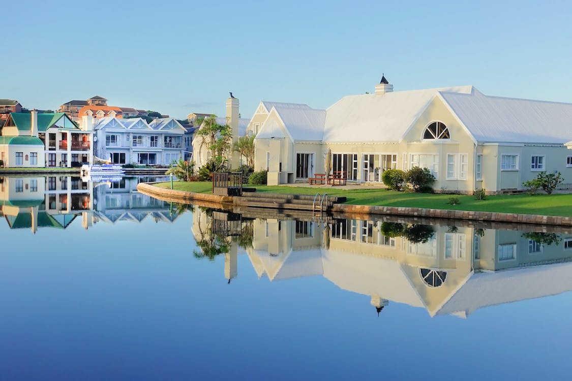 A white house next to the lake