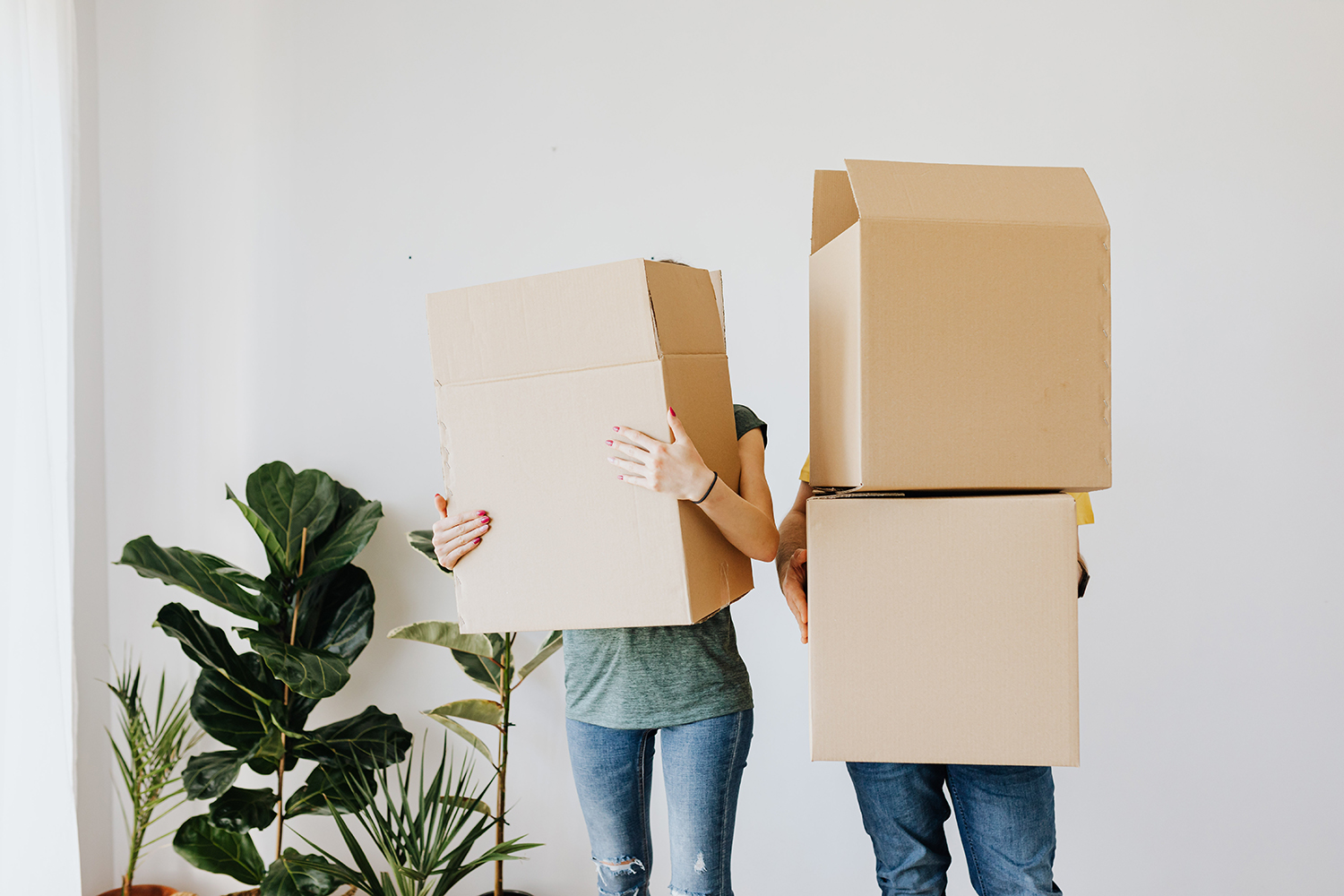 Man and woman holding boxes
