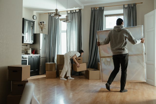 The couple is unpacking their belongings in their new home